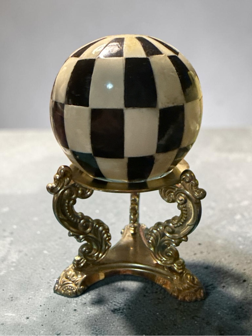 Black and White Checkerboard Decorative Sphere on Ornate Gold Stand